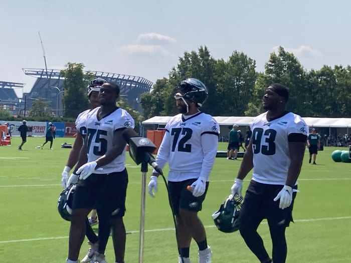 Eagles rookie defensive lineman Tarron Jackson (75), Marlon Tuipulotu, and Milton Williams leave the pratice field on July 27, 2021